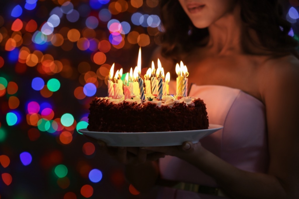 birthday party commit woman holding cake