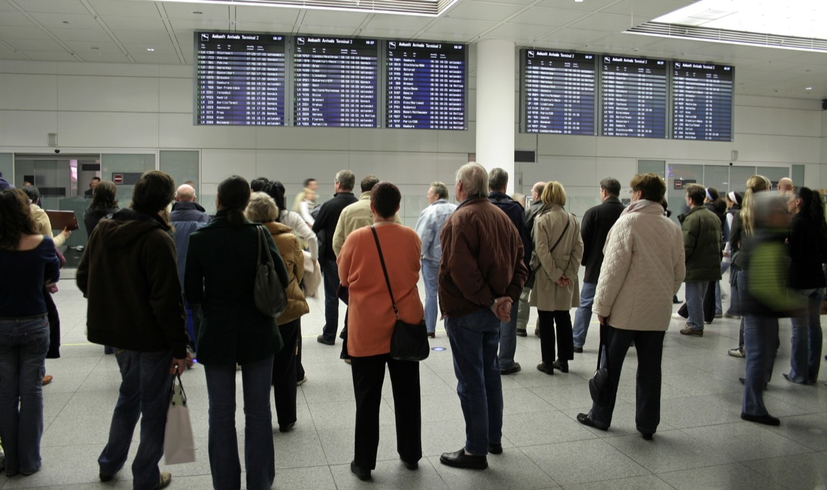 crowd waiting at arrival gate for passengers to exit