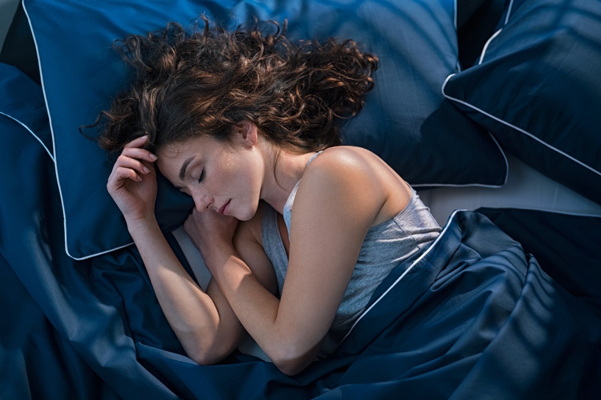 Woman Sleeping in Blue Bed