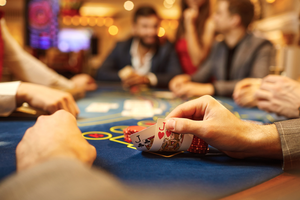 A closeup of a player's pocket jack cards in a game of poker at a casino