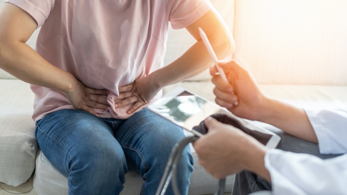 Abdominal pain patient woman having medical exam with doctor