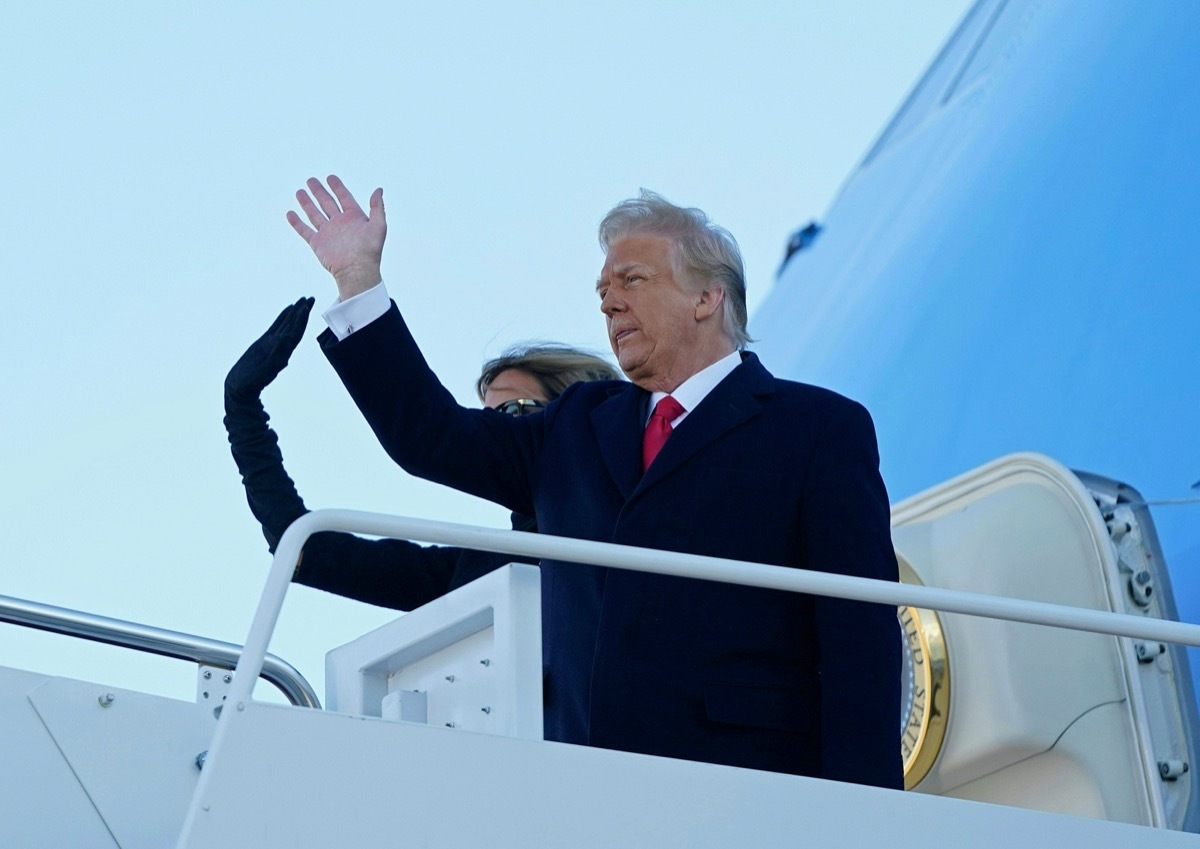 donald and melania trump wave from the steps of air force one