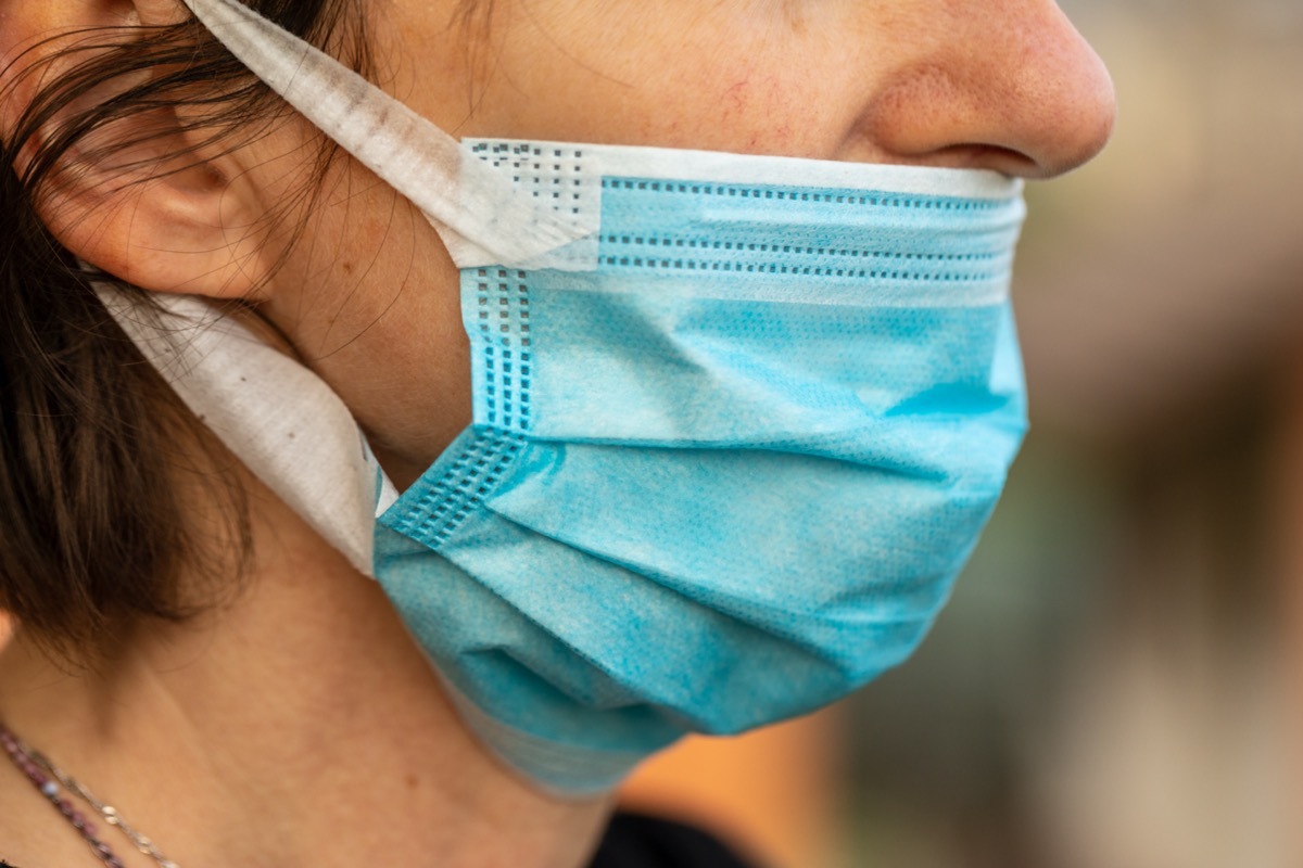 white woman wearing mask wrong below her nose