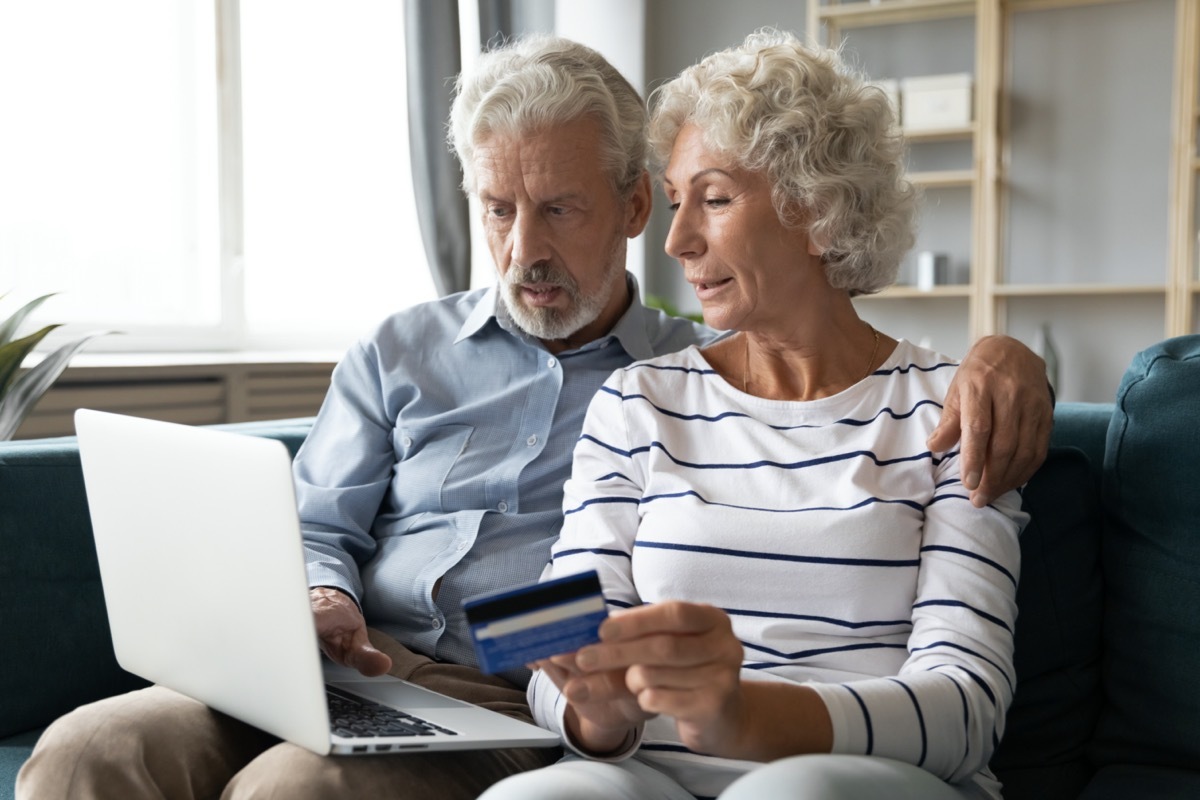 older straight white couple paying bills