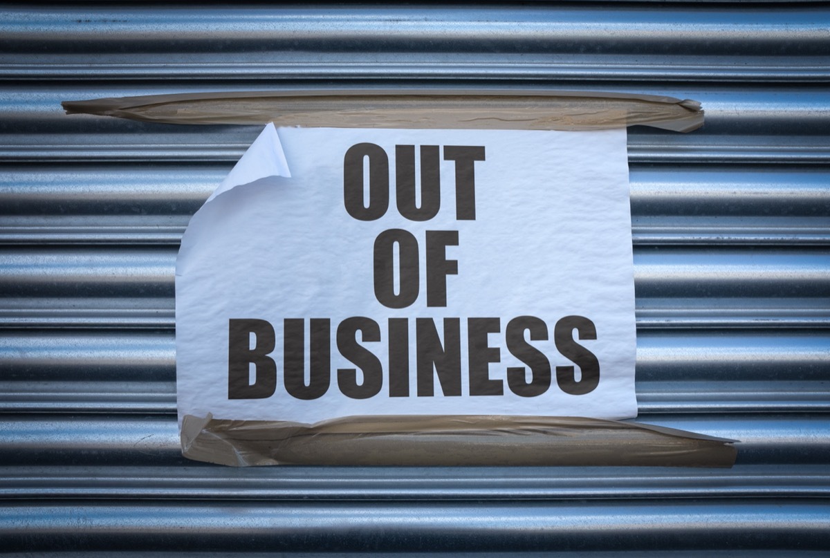 paper out of business sign on metal store grate