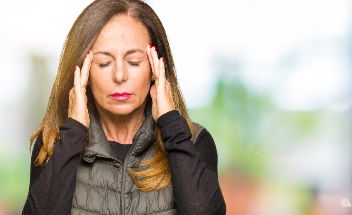 Stressed woman rubbing her temples