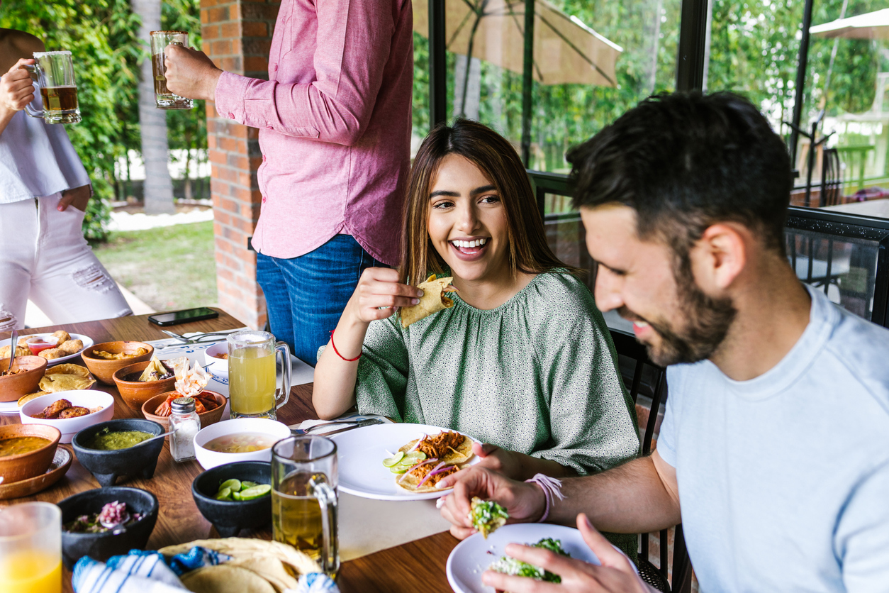 Group of latin friends eating mexican food in the restaurant terrace in Mexico Latin America