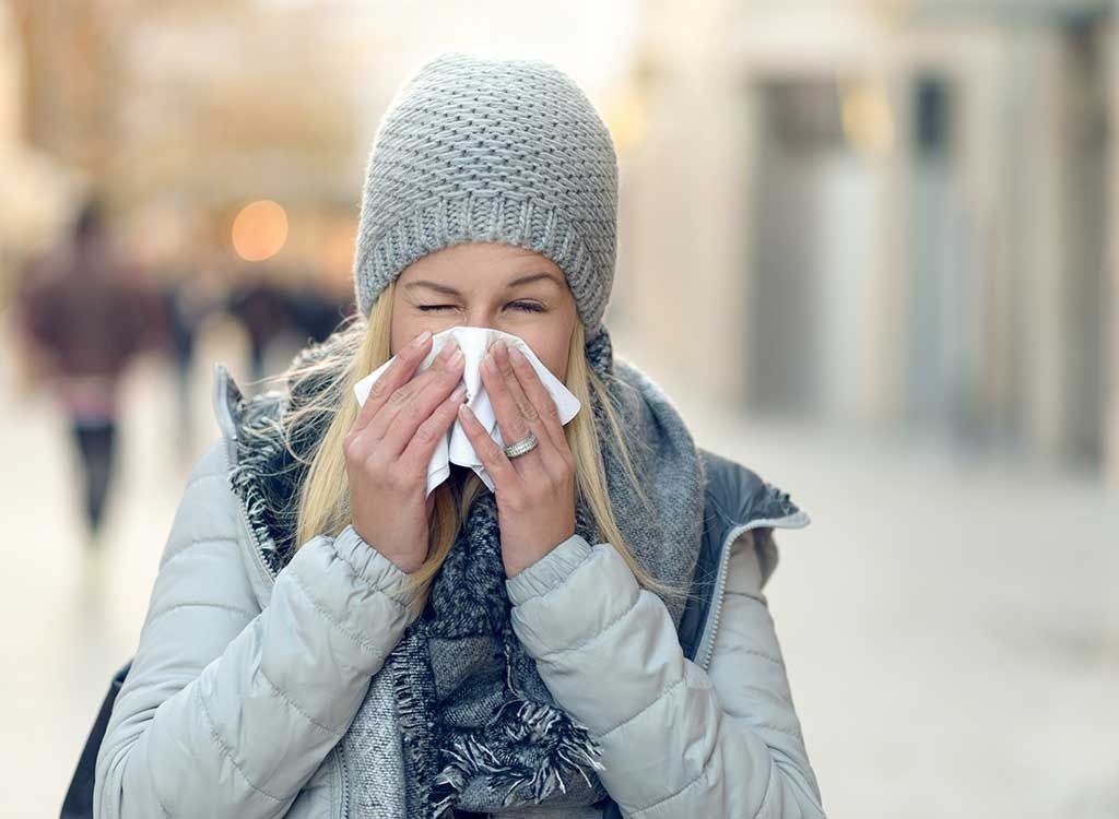 woman blowing nose