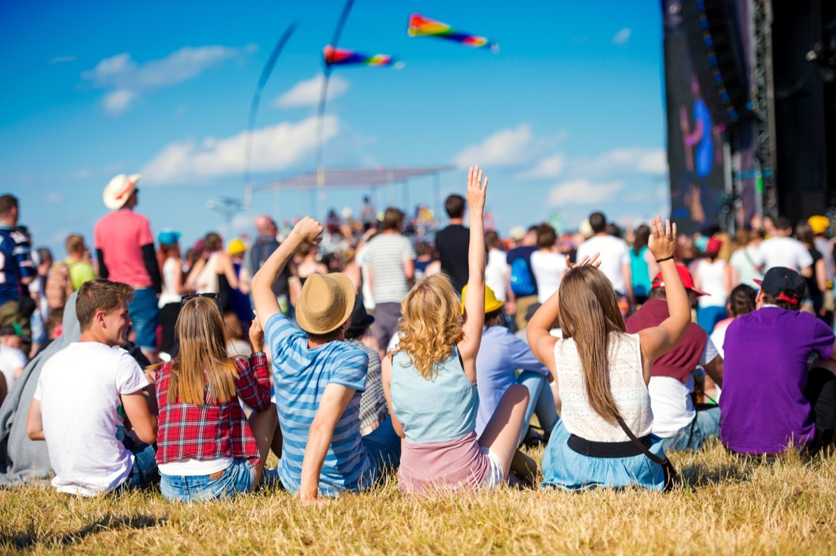 young people sitting outside at a concert