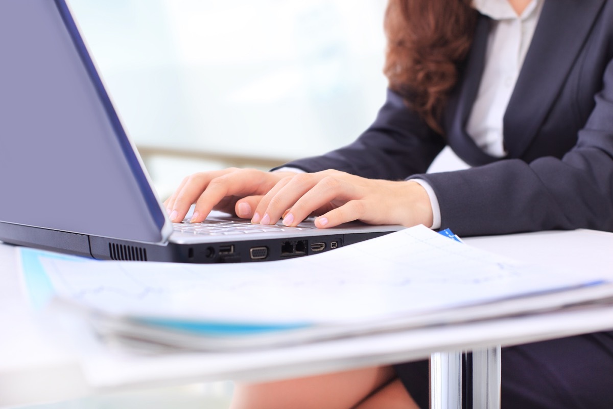 Business woman in the office, work at the computer, close-up.