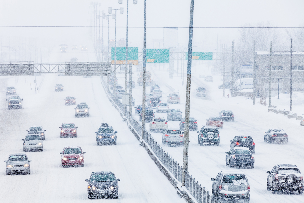 Cars driving on the highway during a snowstorm