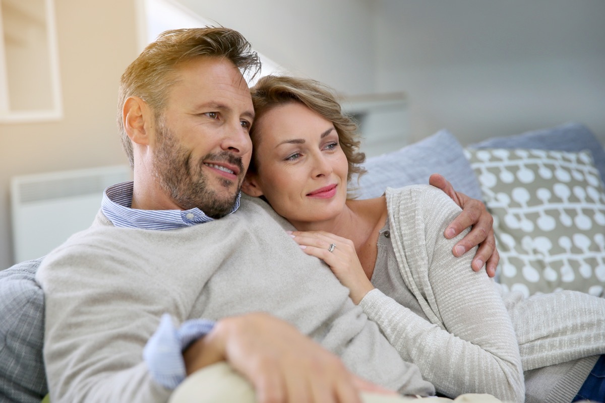 Couple cuddling on couch