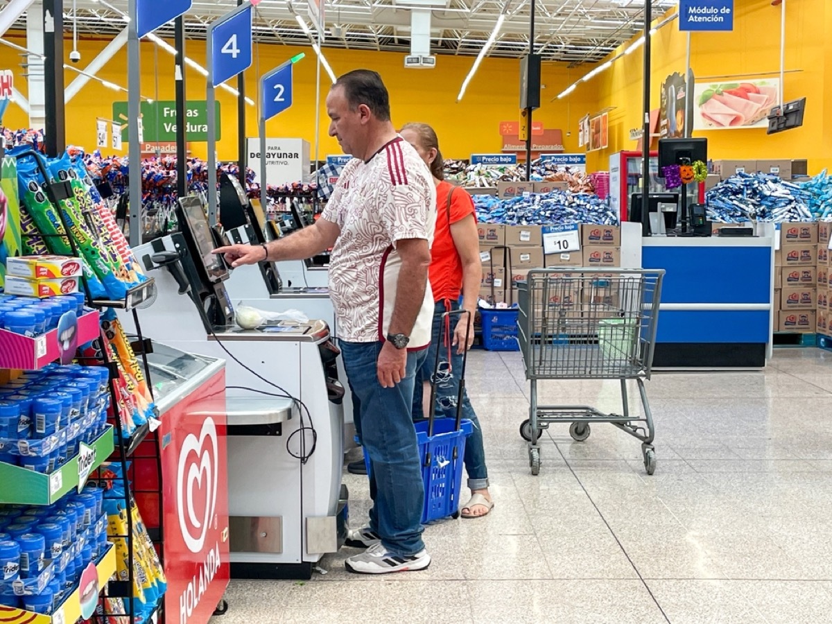 customers using self-checkout at walmart