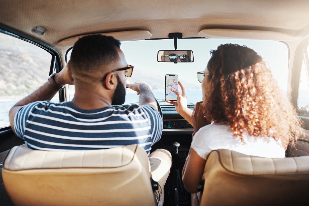 young couple using a GPS machine in their car, NASA everyday items