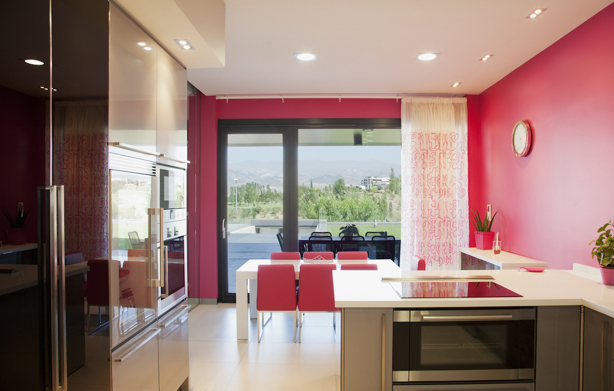 Modern kitchen with bright pink walls