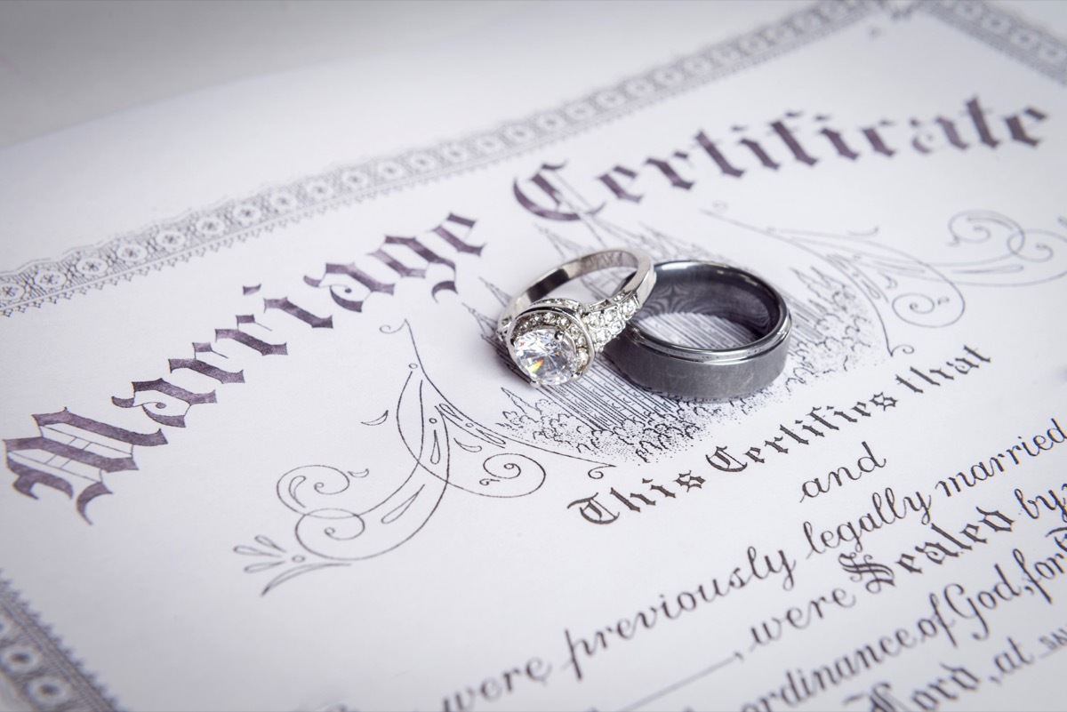 marriage certificate on the table with rings