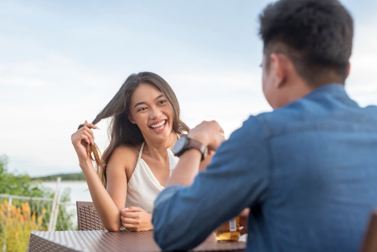 woman twirling her hair on a date