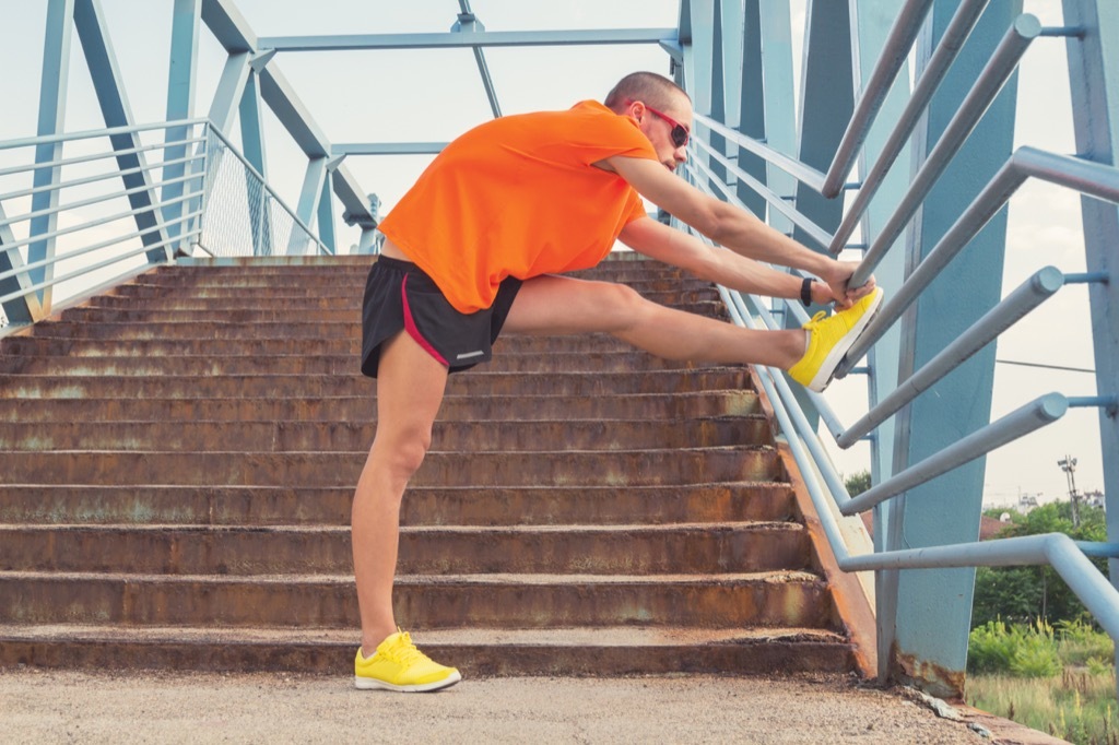 man stretching and groaning