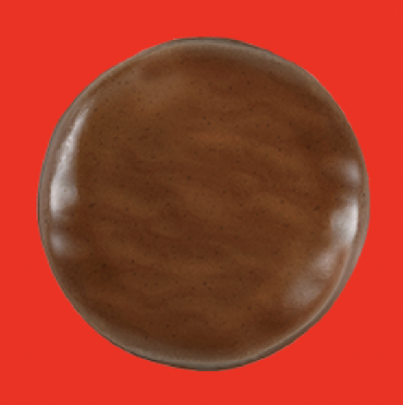 A Girl Scout Tagalong cookie against a red background