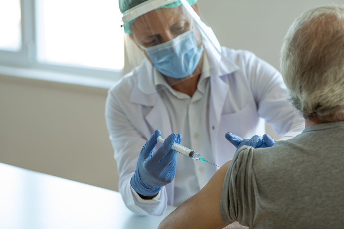 Injecting covid vaccine into patient's arm