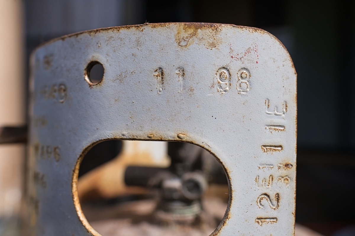 Rusty propane tank with stamped dates