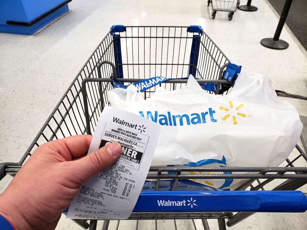 Walmart shopping cart with bag and receipt in Walmart store