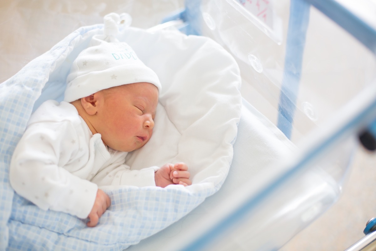 Newborn baby in a crib 