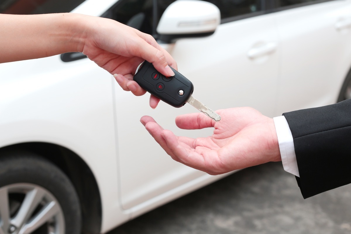 man getting the key for his rental car