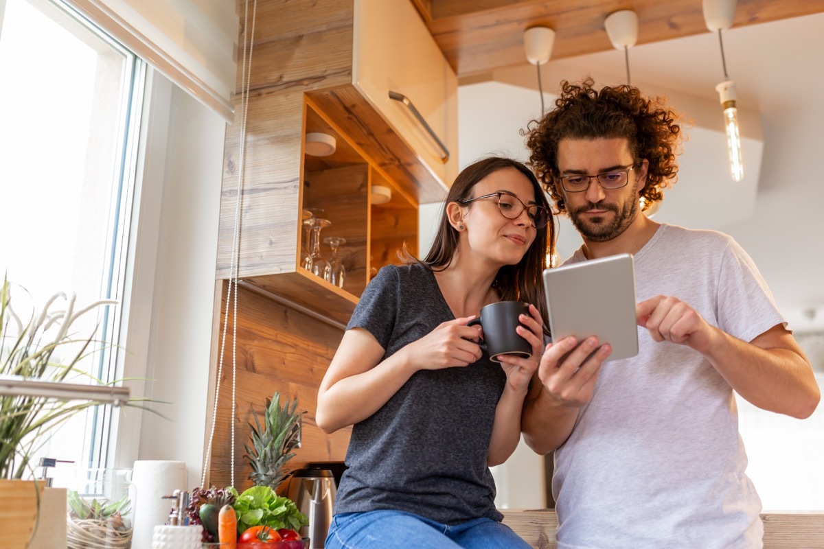 Couple reading on tablet together