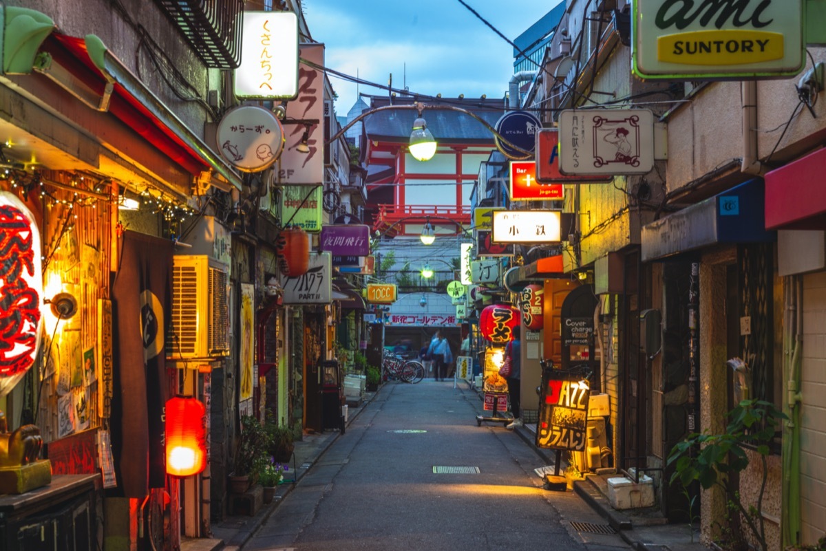 narrow street filled with tiny bars in tokyo