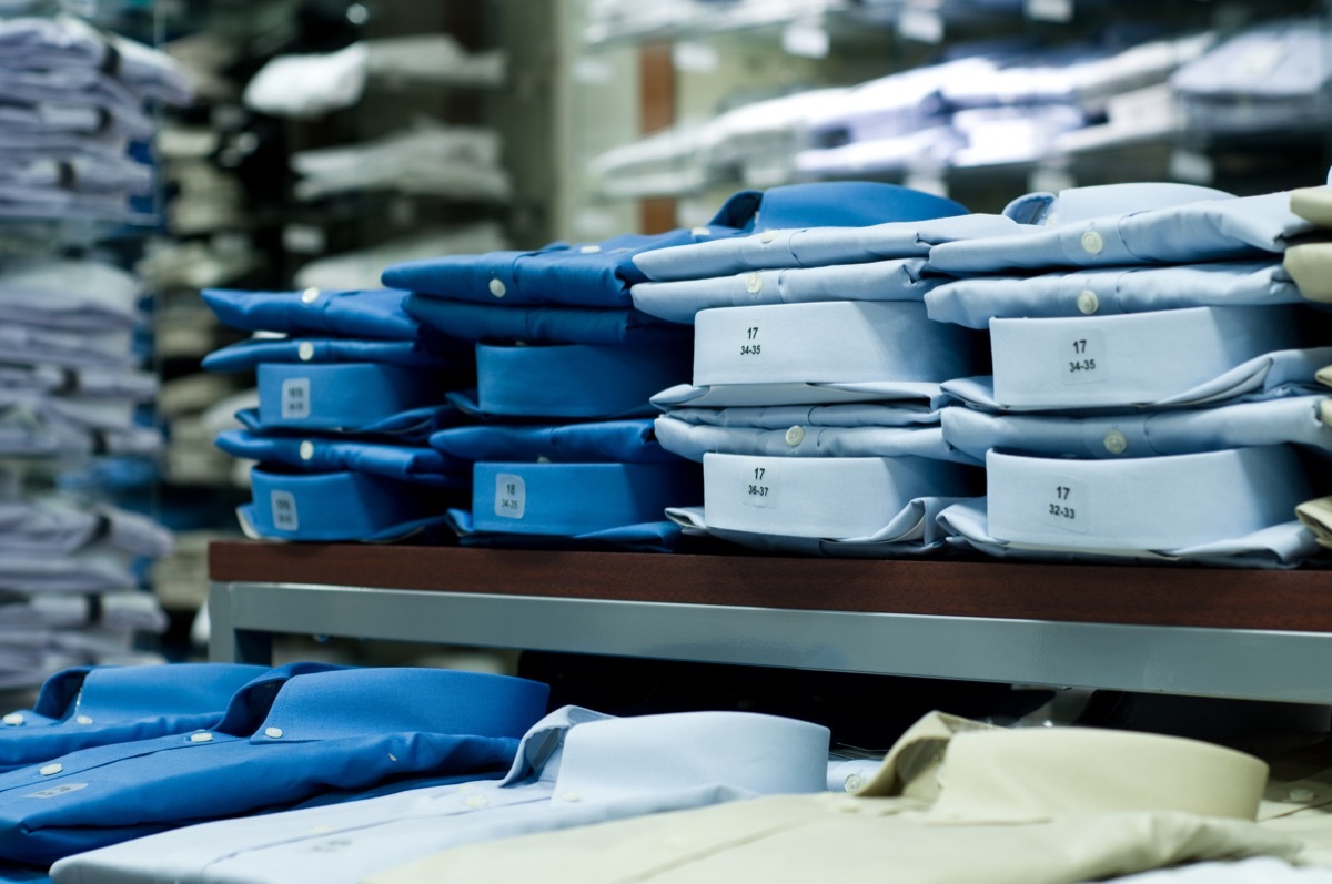 blue folded button-down shirts on a shelf in a store