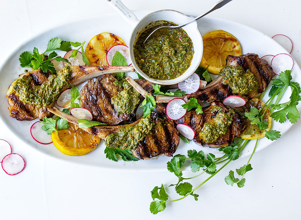 grilled lamb chops with sauce on serving platter