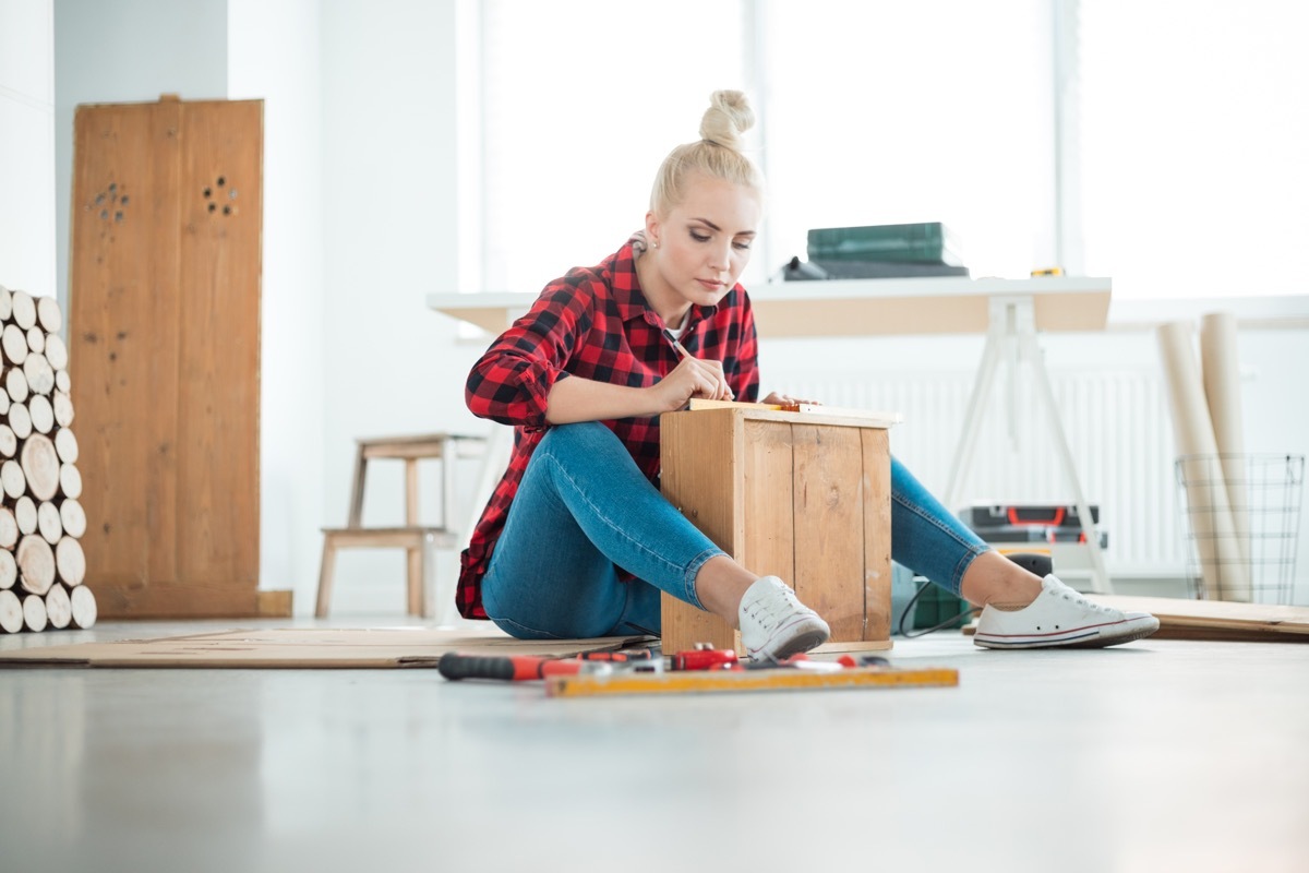 Woman doing DIY project on a drawer