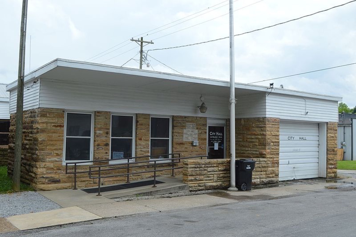 Front of the Golconda city hall, located at 118 Monroe Street in Golconda, Illinois, United States. According to the plaque, it was built by the National Youth Administration in 1940.