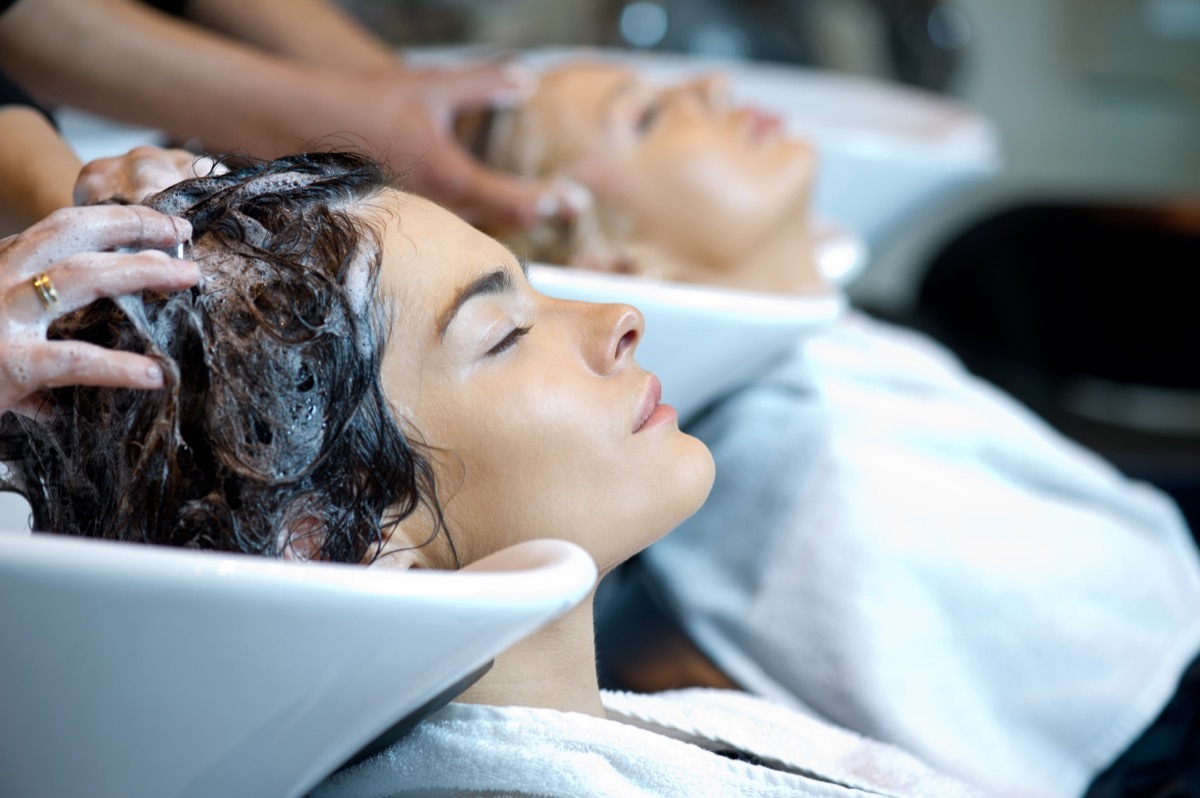 Beautiful woman getting a hair wash. In a hair salon