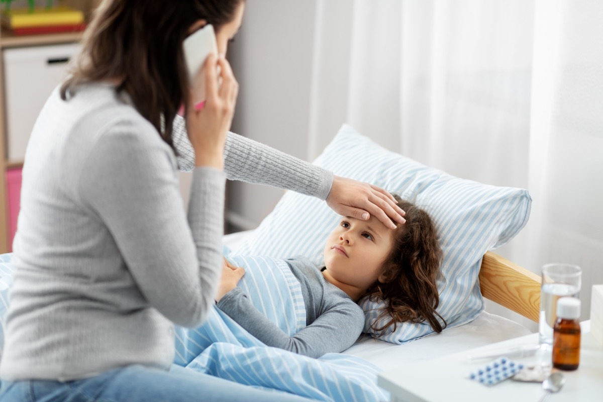 mother with sick child calling doctor