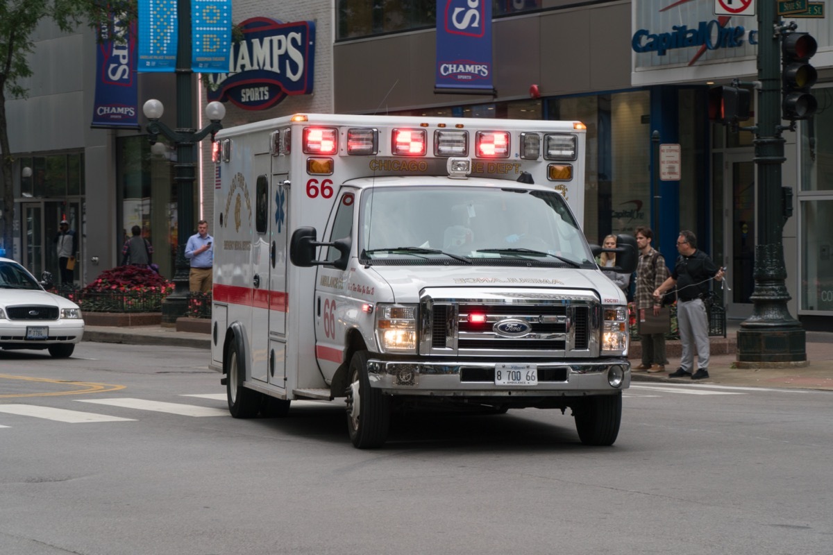 cago PD ambulance rushing through downtown intersection towards emergency