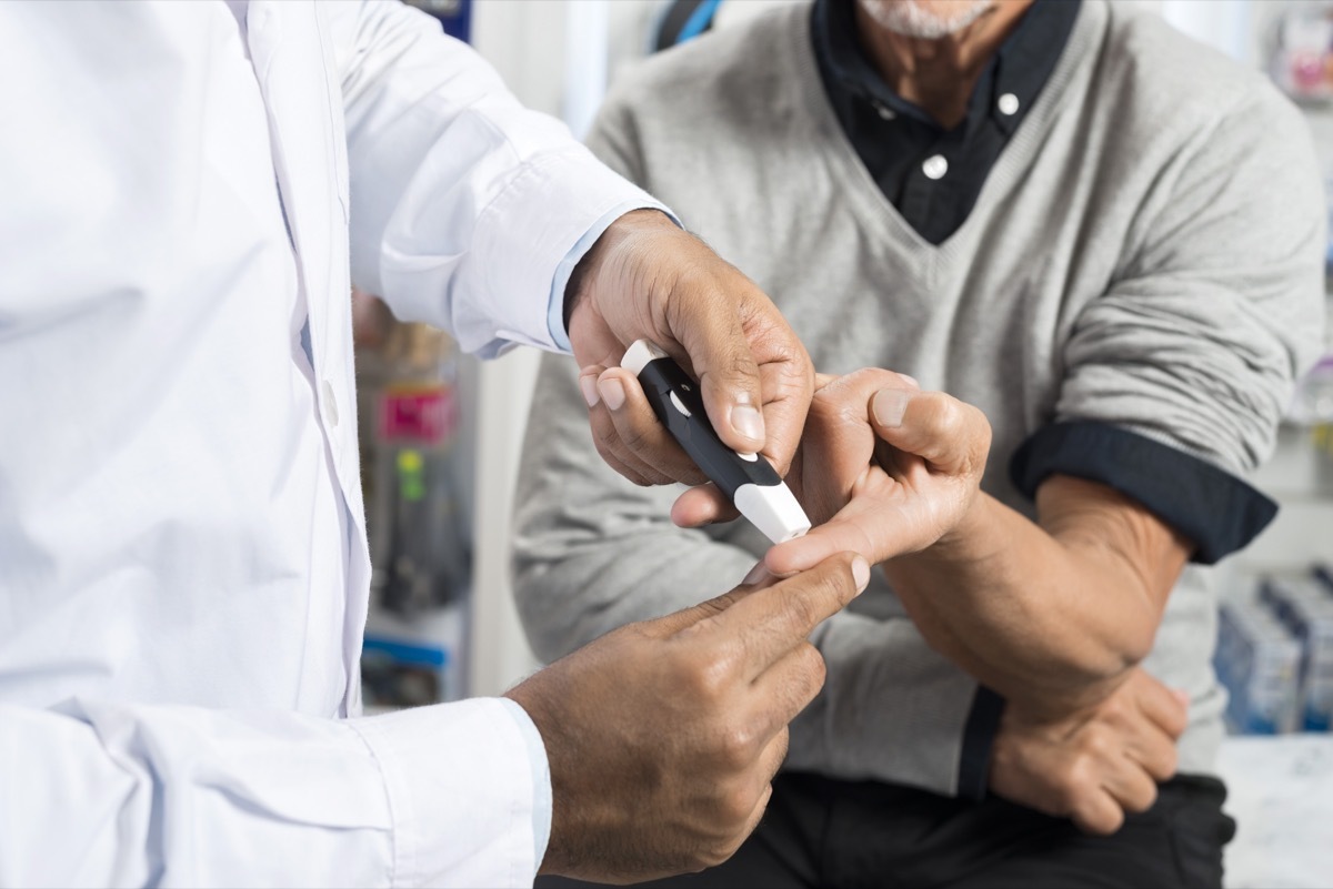 man getting a diabetes test at the doctors office