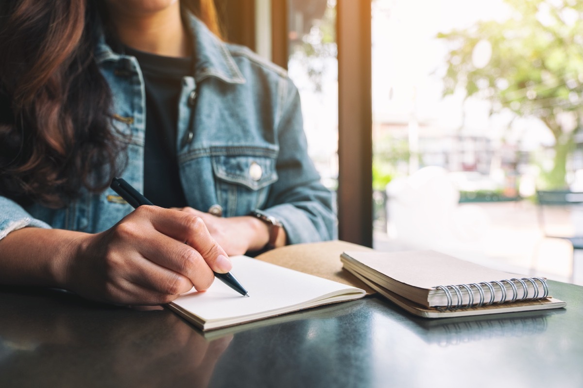 Woman writing in journal