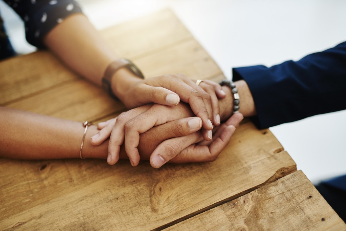 Closeup shot of two unrecognizable people holding hands in comfort