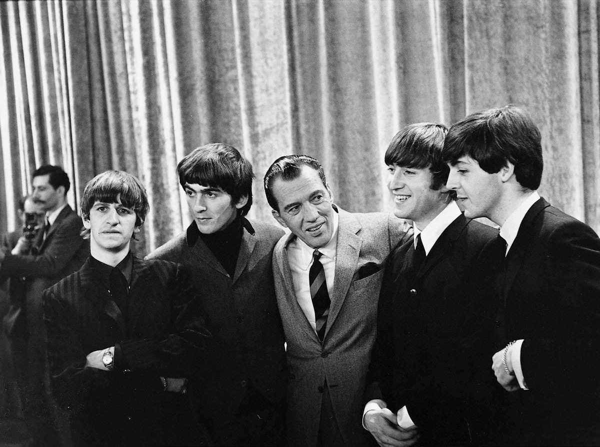 Photo of The Beatles with Ed Sullivan from their first appearance on Sullivan's US variety television program in February 1964. From left: Ringo Starr, George Harrison, Ed Sullivan, John Lennon, Paul McCartney.