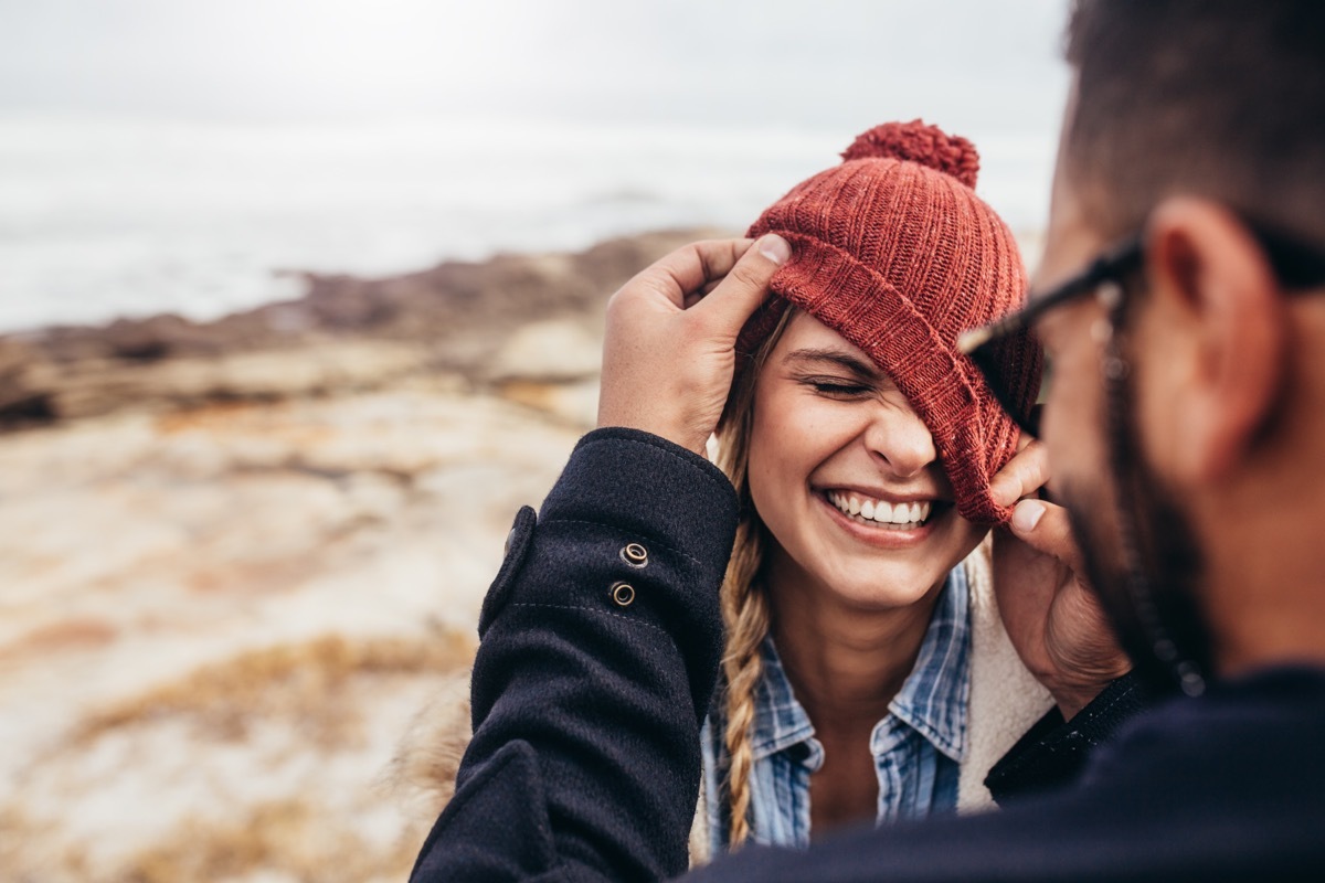 Close up portrait of smiling young couple having fun outdoors.