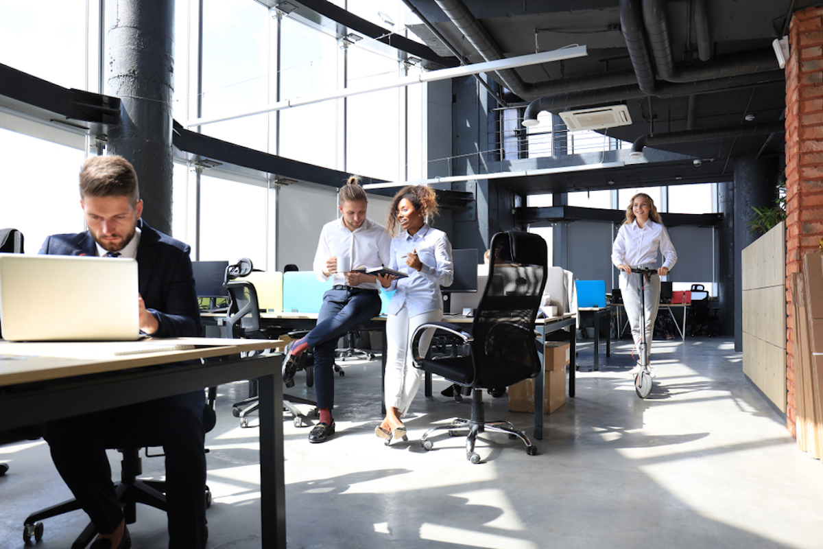 young people of various races working in open office