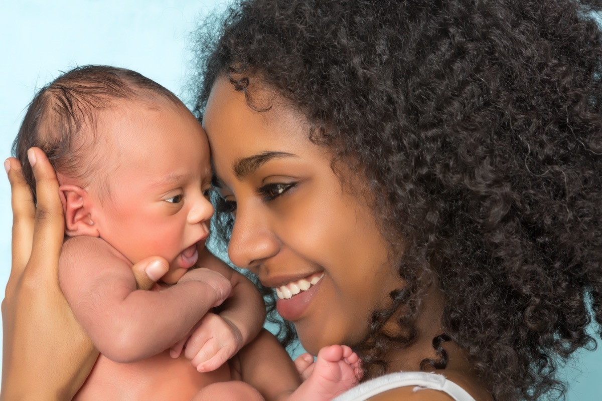 mother holding her 11 days old newborn baby