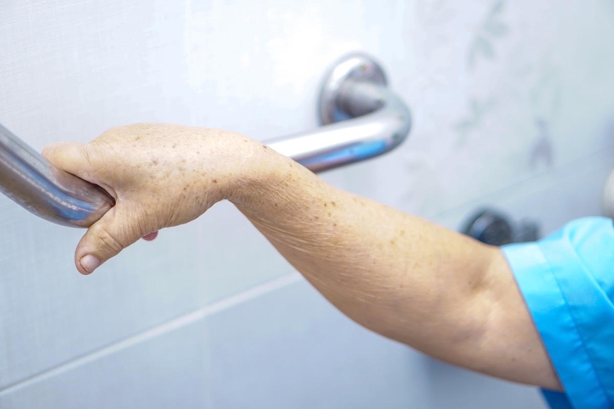 enior or elderly old lady woman patient use toilet handle security in nursing hospital : healthy strong medical concept