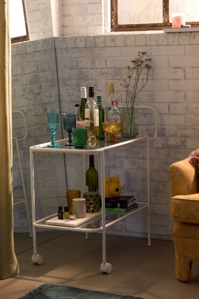 gold bar cart with cocktail shaker on it, kitchen decorations