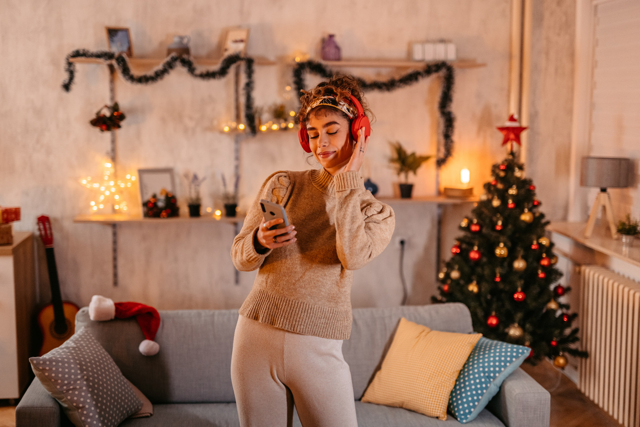 young woman singing christmas song at home