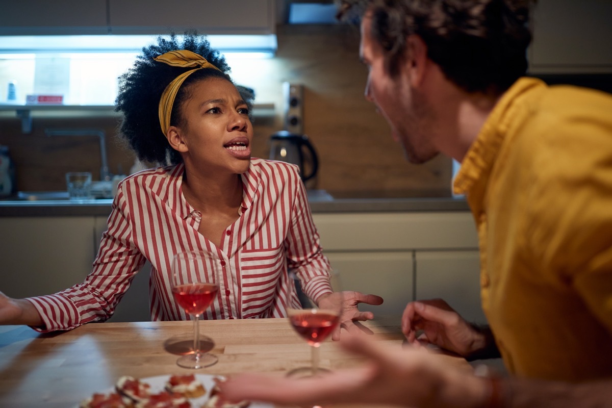 young couple arguing at table