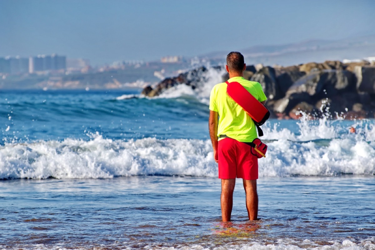 lifeguard standing in the water at the beach