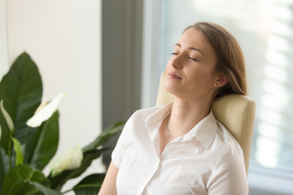 young blonde woman relaxing at work